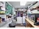 Laundry room features a washer, dryer, cabinets, and shelving with supplies at 3329 W 10Th St, Indianapolis, IN 46222