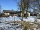 Ranch style home featuring an attached garage and snow covered lawn at 338 A St, Wilkinson, IN 46186