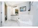 Elegant bathroom featuring a soaking tub and modern white cabinets at 355 E Ohio St # 116, Indianapolis, IN 46204