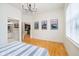 Bright bedroom with hardwood floors and a partial view of the en-suite bathroom at 355 E Ohio St # 116, Indianapolis, IN 46204
