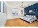 Well-lit bedroom showcasing a blue accent wall and minimalist decor at 355 E Ohio St # 116, Indianapolis, IN 46204