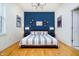 Cozy bedroom with a blue accent wall and stylish decor at 355 E Ohio St # 116, Indianapolis, IN 46204