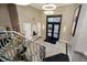 Bright entryway featuring unique lighting, tile flooring, and staircase at 355 E Ohio St # 116, Indianapolis, IN 46204