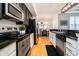 Modern kitchen with stainless steel appliances and black countertops at 355 E Ohio St # 116, Indianapolis, IN 46204