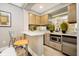 Efficient kitchenette with counter seating and stainless steel appliances at 355 E Ohio St # 116, Indianapolis, IN 46204