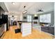 Open-concept living room with fireplace, modern lighting, and hardwood floors at 355 E Ohio St # 116, Indianapolis, IN 46204