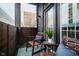 Inviting patio seating area with two wood chairs and a view at 355 E Ohio St # 116, Indianapolis, IN 46204