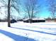 Front exterior of home with snow covered yard and an outbuilding at 401 W Edwards Ave, Indianapolis, IN 46217