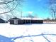Exterior front view of a home with a blue sky and snow-covered yard at 401 W Edwards Ave, Indianapolis, IN 46217