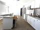Renovated kitchen with white cabinets, granite countertops, a stainless steel microwave, and modern fixtures at 401 W Edwards Ave, Indianapolis, IN 46217