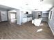Open floor plan with renovated kitchen with white cabinets and new floors at 401 W Edwards Ave, Indianapolis, IN 46217
