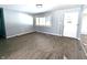 Bright living room featuring a large window, new floors, and a white front door at 401 W Edwards Ave, Indianapolis, IN 46217