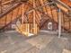 Spacious attic featuring exposed wood beams, natural light, and potential for renovation or additional storage at 422 E Main St, Lebanon, IN 46052