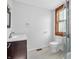 This bathroom features an updated vanity and a tile shower with dark wood trim window at 422 E Main St, Lebanon, IN 46052