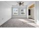 Bright bedroom with carpet, a ceiling fan, and large windows letting in natural light at 422 E Main St, Lebanon, IN 46052