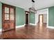 Dining room featuring hardwood floors, a modern light fixture, and vintage hutch at 422 E Main St, Lebanon, IN 46052