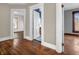 Hallway showing multiple rooms with hardwood floors and white trim around doorways at 422 E Main St, Lebanon, IN 46052