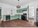 Wide angle of kitchen with black appliances, butcher block countertops, and white subway tile at 422 E Main St, Lebanon, IN 46052