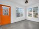 Bright enclosed porch featuring an orange door, multiple windows, and neutral interior at 422 E Main St, Lebanon, IN 46052