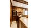 A wood paneled bar with built in shelving and a window view at 426 Oakwood Dr, Indianapolis, IN 46260