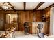 Cozy bar area with seating for two in wood paneled living room at 426 Oakwood Dr, Indianapolis, IN 46260