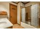 Bathroom featuring a shower-tub combo with decorative glass doors at 426 Oakwood Dr, Indianapolis, IN 46260