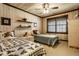 Inviting bedroom featuring two twin beds, wood-paneled walls, and classic ceiling fan at 426 Oakwood Dr, Indianapolis, IN 46260