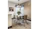 Kitchen eat in area with retro light fixture, mosaic tile, and patterned chairs with tile flooring at 426 Oakwood Dr, Indianapolis, IN 46260