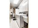 Functional laundry room with white cabinets, vintage washer-dryer, and utility sink at 426 Oakwood Dr, Indianapolis, IN 46260