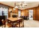 Cozy living room with a fireplace, wood paneling, and a dining area for entertaining guests and Gathering at 426 Oakwood Dr, Indianapolis, IN 46260
