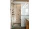 Shower featuring tiled walls, multiple shower heads, and a decorative glass sliding door at 426 Oakwood Dr, Indianapolis, IN 46260