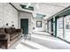 Bright sunroom featuring brick walls, skylights, a ceiling fan, and sliding glass doors to the backyard at 426 Oakwood Dr, Indianapolis, IN 46260