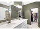 Modern bathroom featuring double sinks, granite counters, and a tiled floor at 4425 Maize Ln, Whitestown, IN 46075