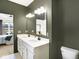 Elegant bathroom with double vanity, framed mirror and olive colored walls at 4425 Maize Ln, Whitestown, IN 46075