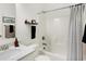 Bright bathroom featuring a shower-tub combo with a modern shower curtain and a sleek vanity area at 4425 Maize Ln, Whitestown, IN 46075