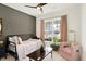 Inviting bedroom with a daybed, pink accent chair, and ample natural light at 4425 Maize Ln, Whitestown, IN 46075