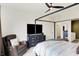 Comfortable bedroom featuring a four-poster bed, modern dresser, and relaxing reading chair at 4425 Maize Ln, Whitestown, IN 46075
