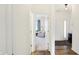 Hallway with hardwood floors leading to a living area and an entryway with natural light at 4425 Maize Ln, Whitestown, IN 46075