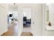 Hallway view showcasing hardwood flooring, doorways leading to various rooms, and natural light at 4425 Maize Ln, Whitestown, IN 46075
