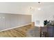 Bright living room features wood floors, a stylish rug, and a decorative wainscoting accent wall at 4425 Maize Ln, Whitestown, IN 46075