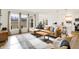 Bright and airy living room with hardwood floors, modern furniture, and a view of the backyard at 4425 Maize Ln, Whitestown, IN 46075
