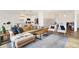 Open-concept living room with a modern kitchen, comfortable seating, and hardwood floors at 4425 Maize Ln, Whitestown, IN 46075