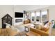 Cozy living room with a fireplace, large windows, and a comfortable leather couch at 4425 Maize Ln, Whitestown, IN 46075