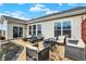 Cozy outdoor patio with stylish seating, a fire pit, and charming string lights at 4425 Maize Ln, Whitestown, IN 46075