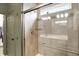 Tiled shower featuring a glass door, a shower caddy, and chrome fixtures at 4425 Maize Ln, Whitestown, IN 46075