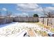 Fenced backyard covered in snow and a play area at 4438 Fullwood Ct, Indianapolis, IN 46254