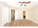 Bedroom featuring a ceiling fan and two doorways, one leading to a bathroom at 4438 Fullwood Ct, Indianapolis, IN 46254