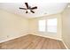 Bright bedroom with a ceiling fan, new windows, and wood-look vinyl flooring at 4438 Fullwood Ct, Indianapolis, IN 46254