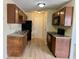 A well-lit kitchen offers wood cabinets, stone countertops, and a new range of black appliances at 4438 Fullwood Ct, Indianapolis, IN 46254