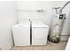 Functional laundry area equipped with a washer, dryer, and water heater at 4438 Fullwood Ct, Indianapolis, IN 46254